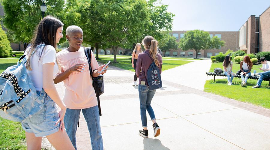 a student showing another student her phone screen