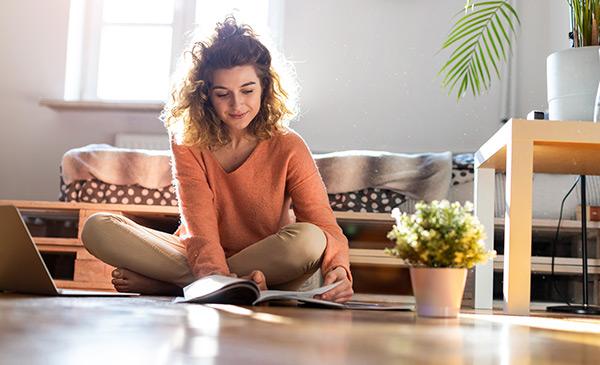 young woman sitting on apartment floor