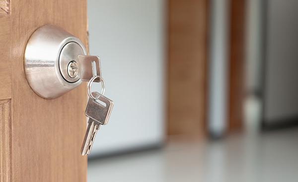 apartment door with a key in it